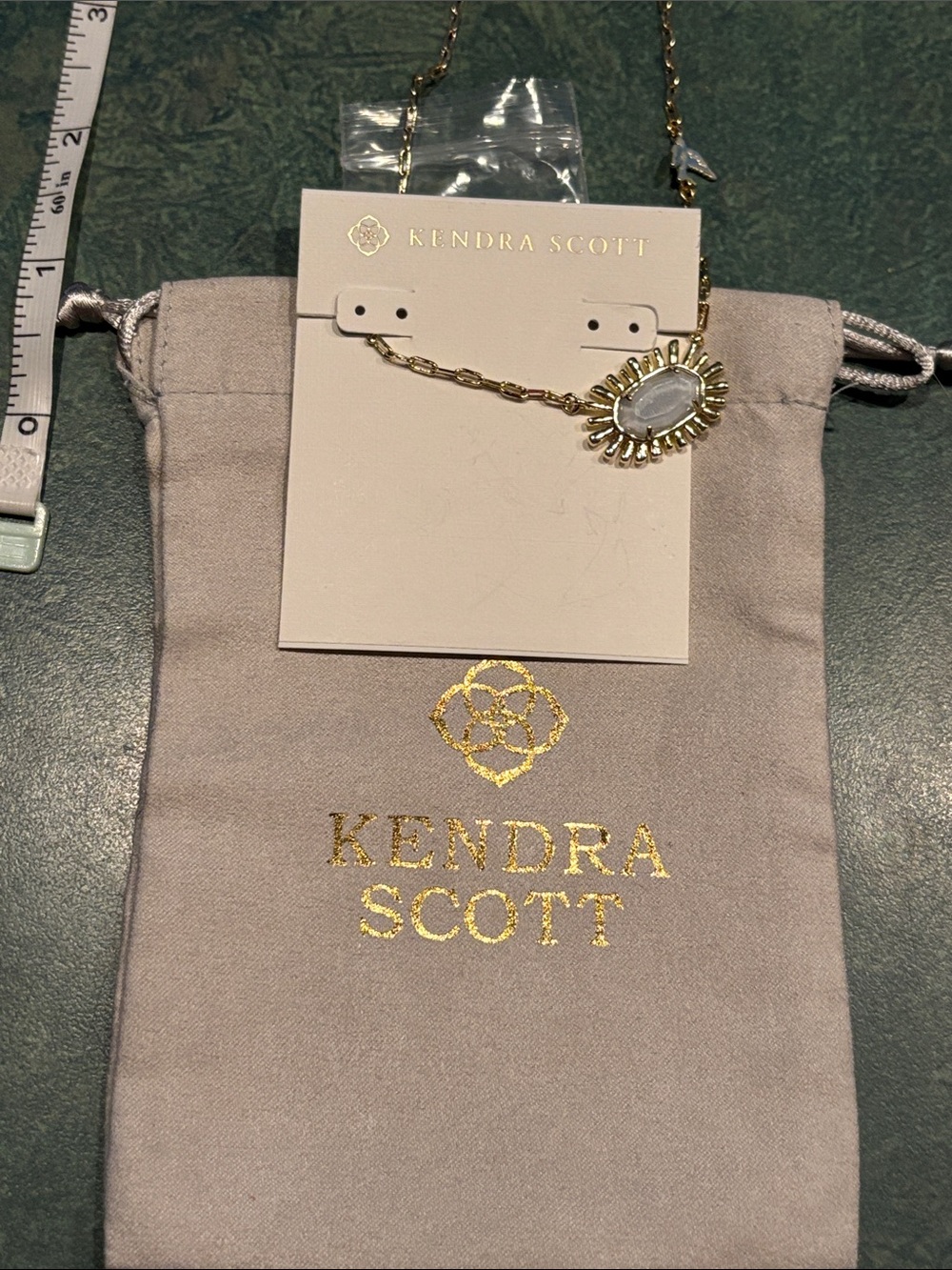 Brand new Kendra Scott Gold Sunburst Necklace with White /grey Stone
